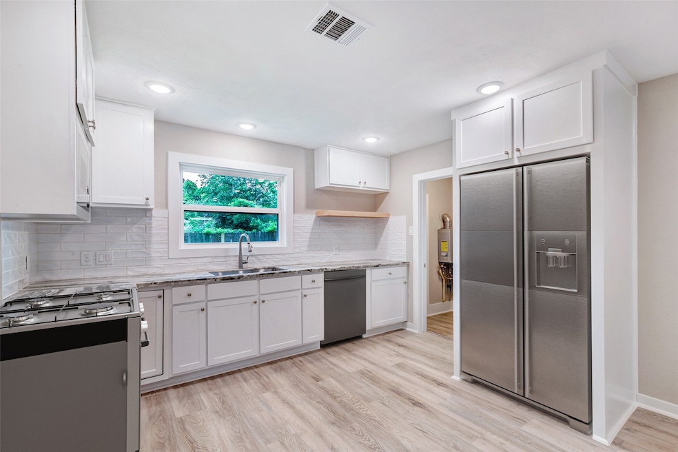 Welcome to 5858 Beldart Street! The kitchen opens