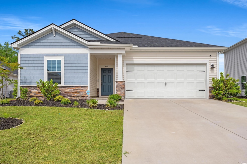 Craftsman-style home with a garage, a front yard, 