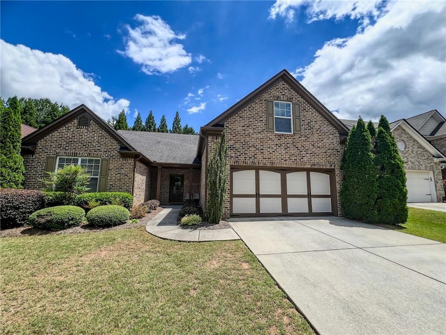 Traditional-style house with brick siding, drivewa