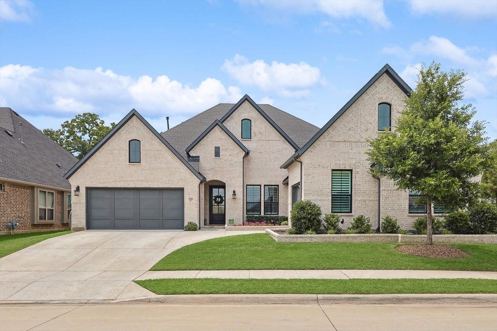 French country style house featuring a garage and 