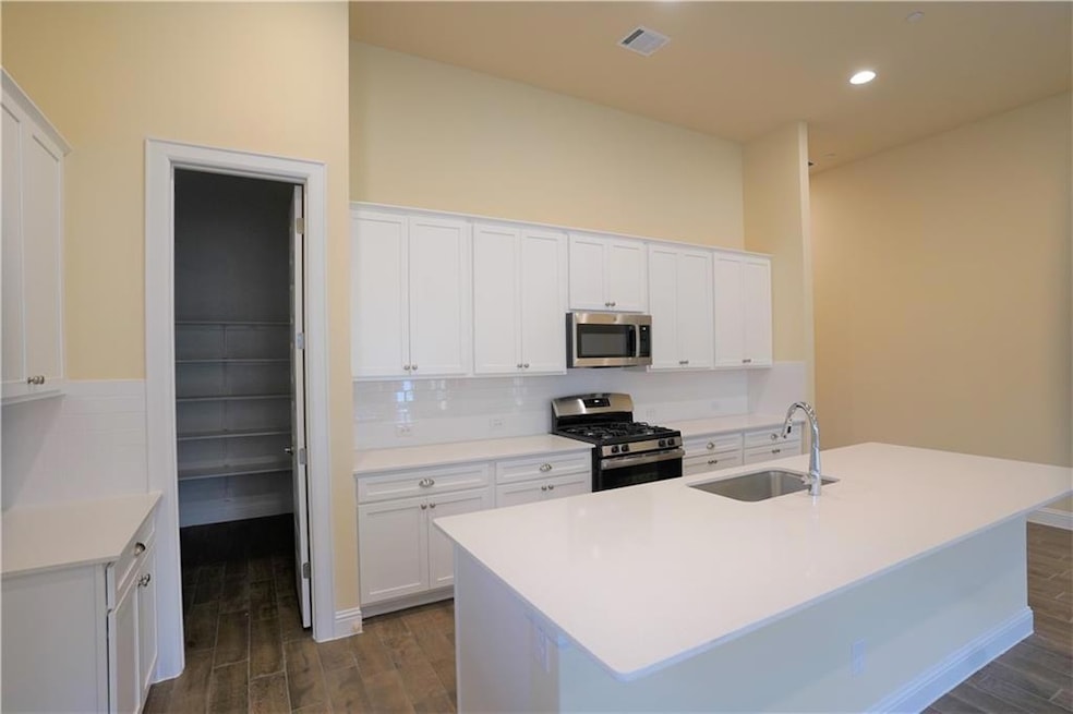 Kitchen with stainless steel appliances, a sink, 