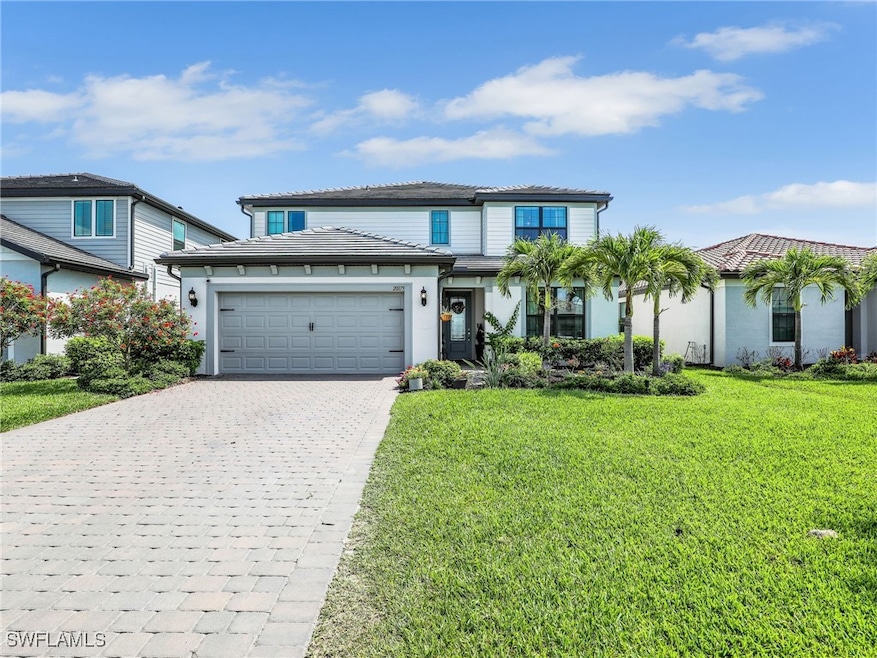 Traditional-style house with decorative driveway,
