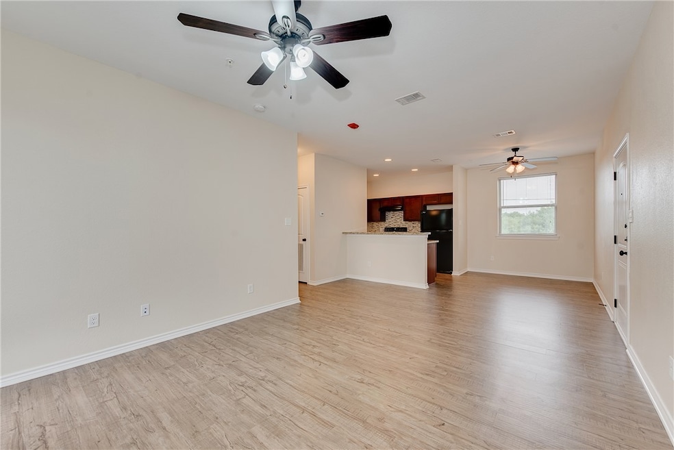 Unfurnished living room with light wood-style floo