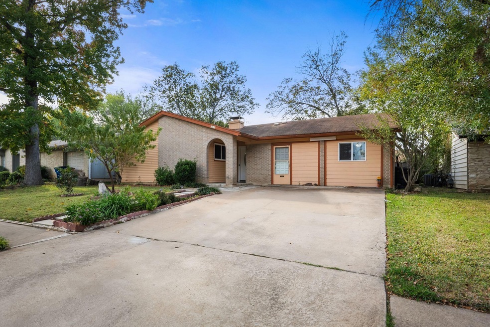View of front of home featuring brick siding, dri