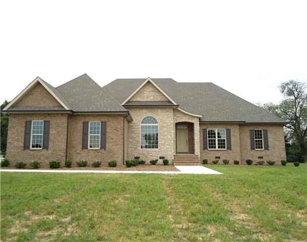 64 Wellington Dr. welcomes you with a brick/rock exterior, landscaping, and wide brick entry steps.