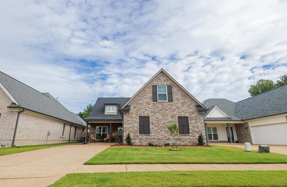 View of front of house with a front lawn and a gar