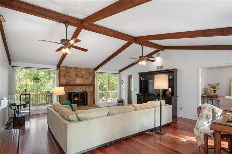 Spacious family room,wood floors, vaulted wood bea