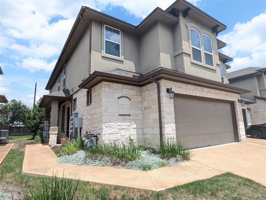 View of front of home featuring driveway, fence, 