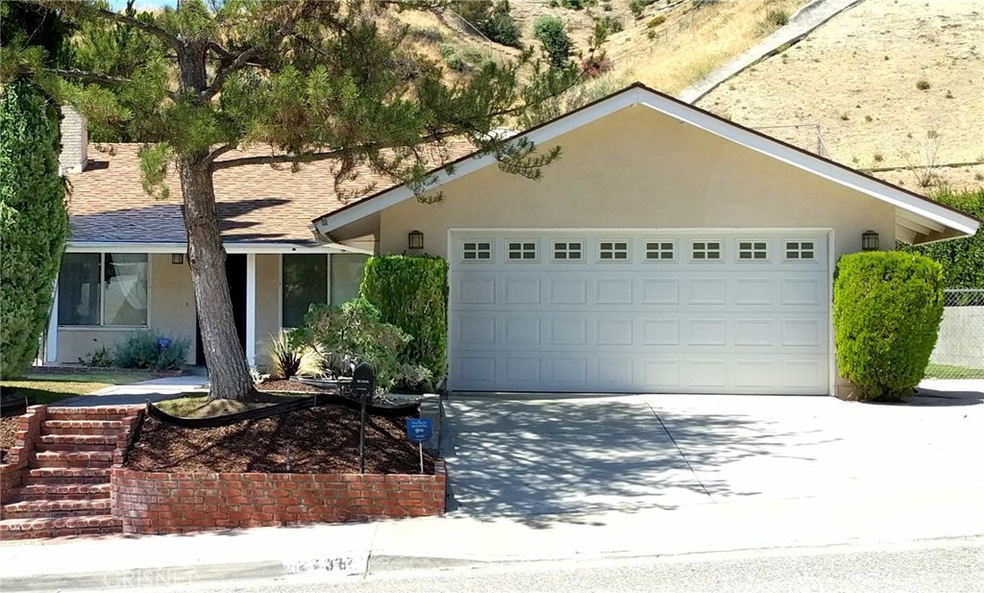 Front of House from Across The Street. Detached garage, with RV parking on the right side.