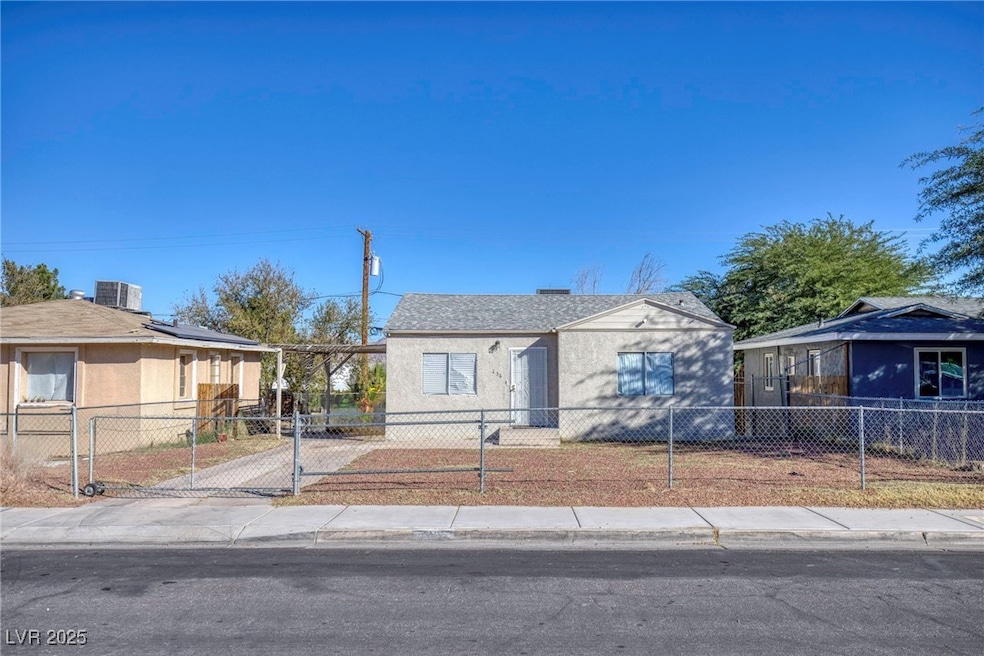 Bungalow-style house with a fenced front yard and a gate