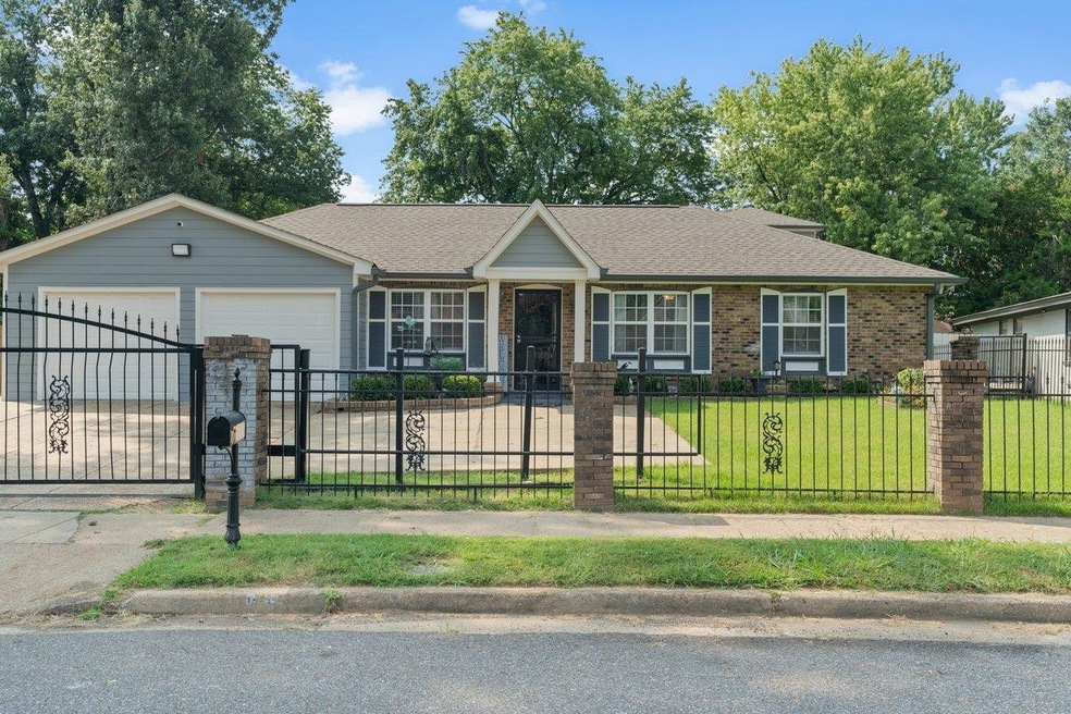 Ranch-style house featuring a front yard and a gar