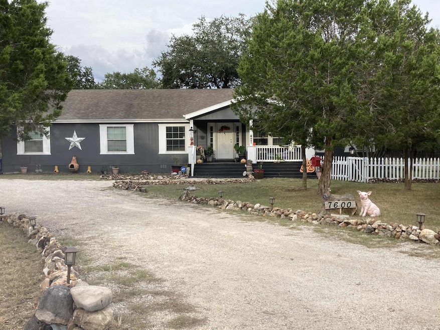 View of front of home featuring a porch, roof wit