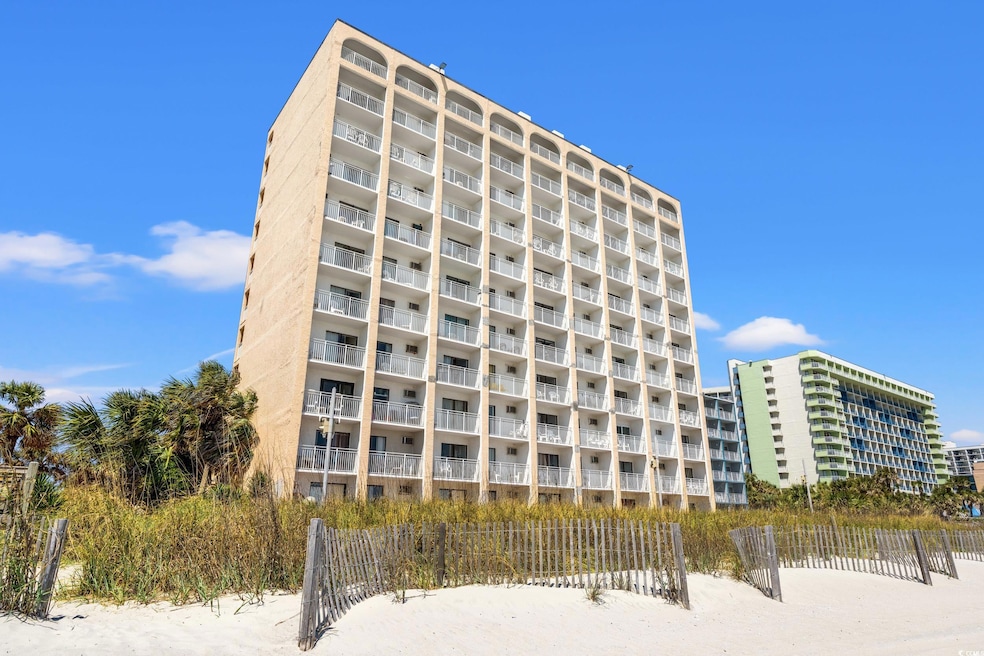 View of building exterior featuring fence
