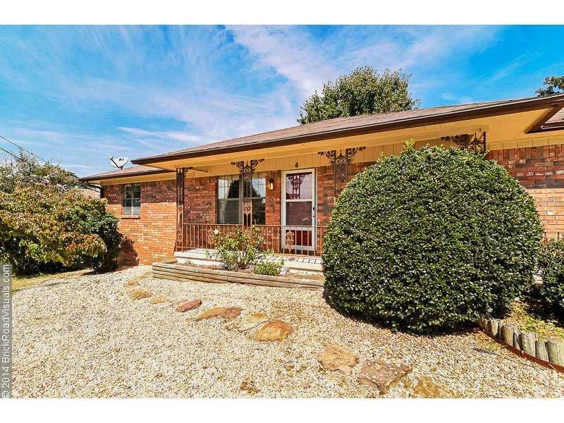 Exterior Front. Pretty landscaping & wrought iron railing gives the home great curb appeal.