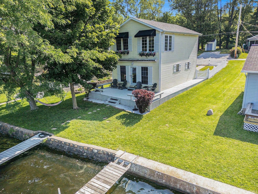 With curb appeal on both sides, this charming house is easy to spot from the lake with its awnings and window boxes.