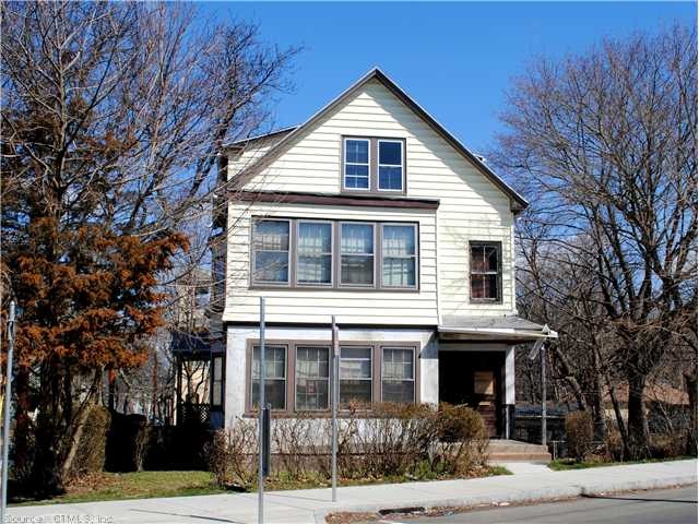 Exterior Front. Large 3 Family home with stucco an