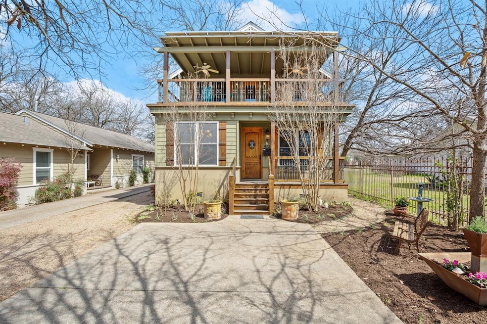 View of front of home featuring a balcony and covered porch