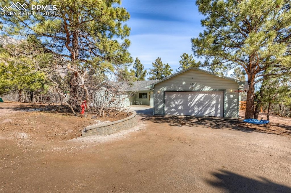 View of front of house featuring driveway and a ga
