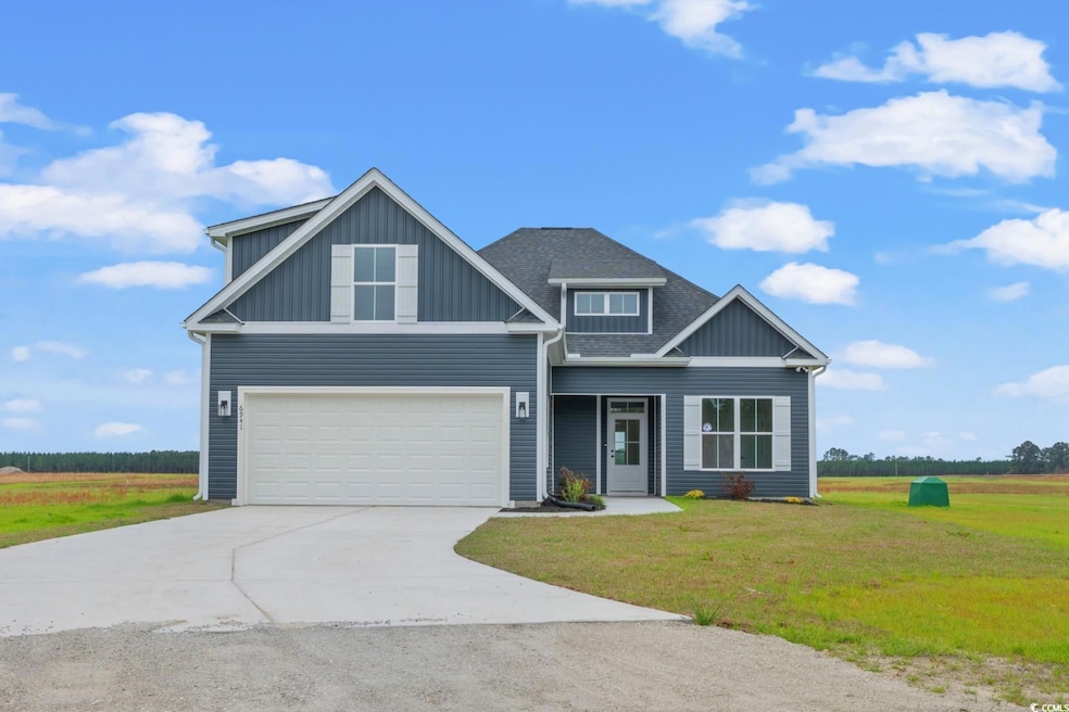 Craftsman house with a front yard and a garage