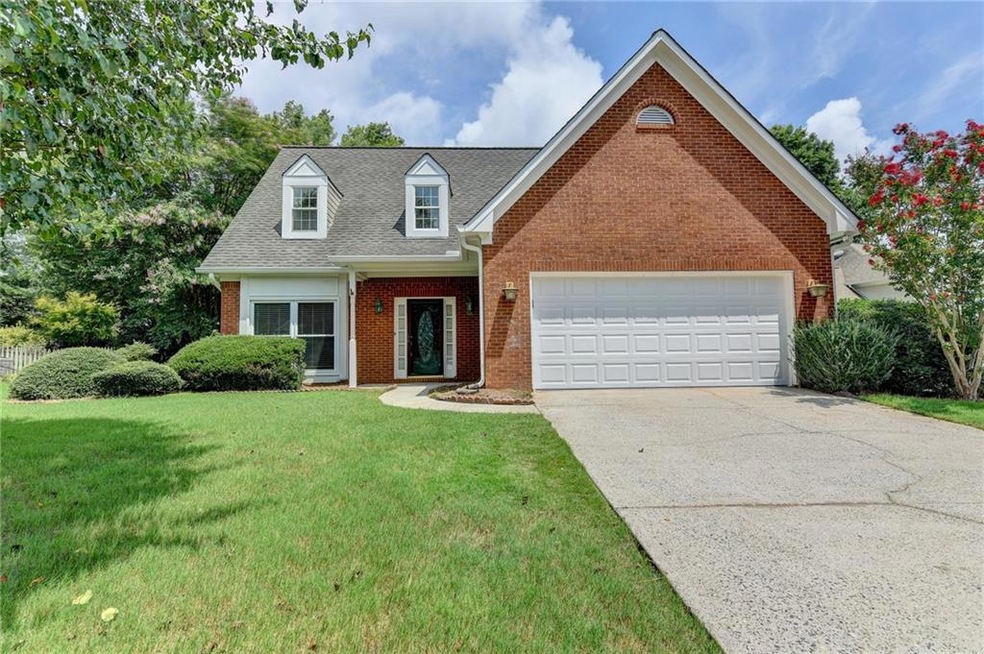 View of front of home with a garage and a front la
