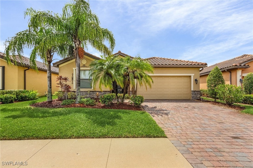 Mediterranean / spanish-style home featuring a gar