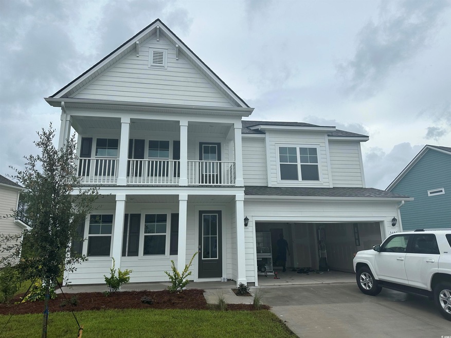 View of front of property with a garage and a balc
