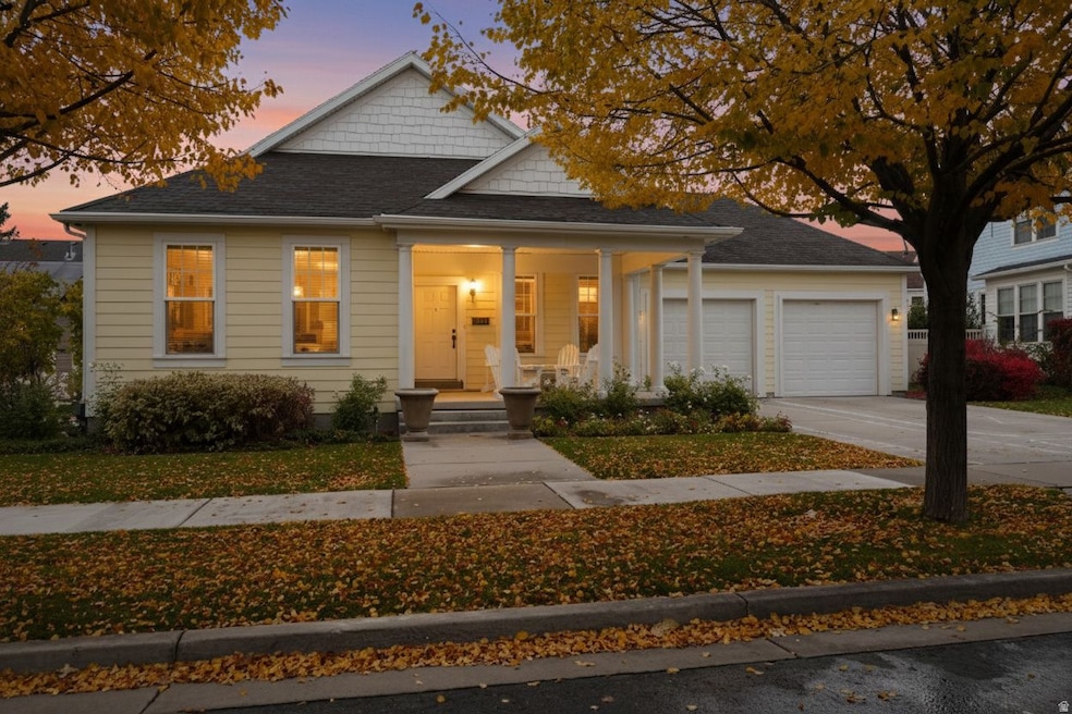Bungalow-style house with covered porch, concrete driveway, a shingled roof, and a garage