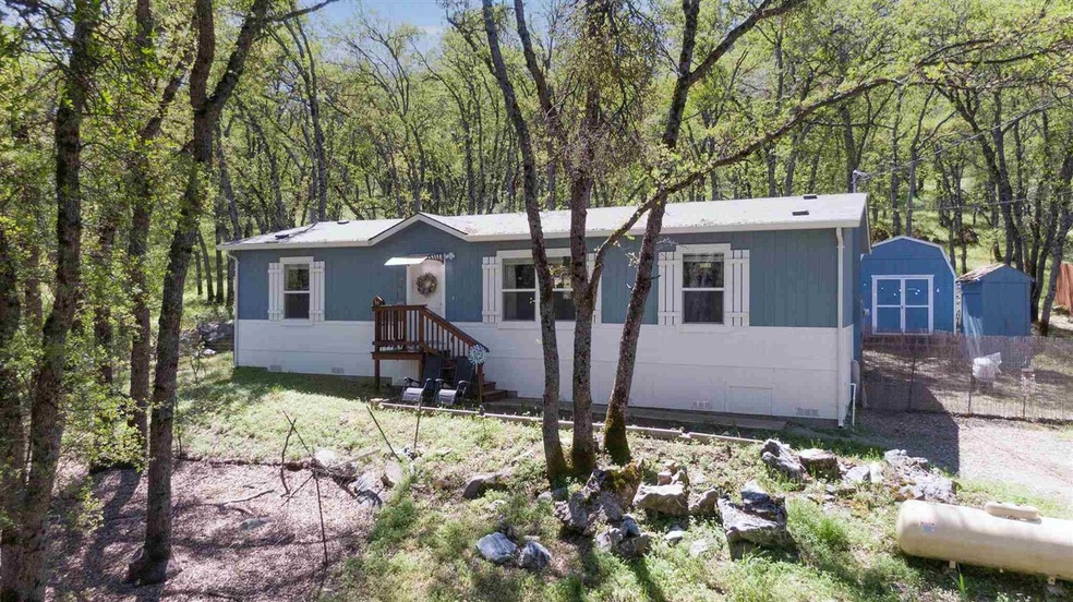 View of front of property featuring a storage shed