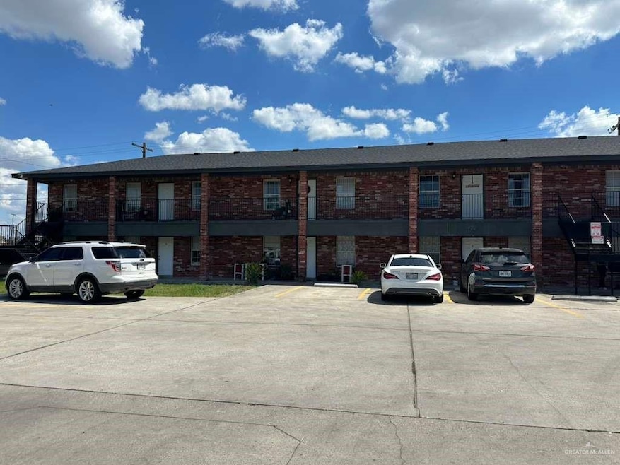 View of building exterior featuring uncovered parking