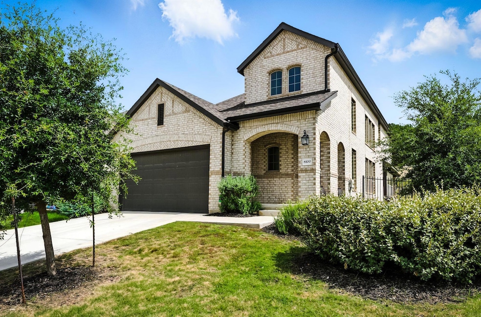 French country home with brick siding, concrete d