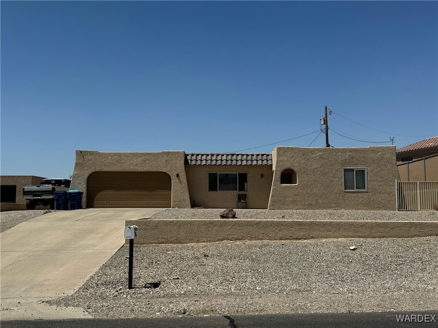 Southwest-style home featuring a garage