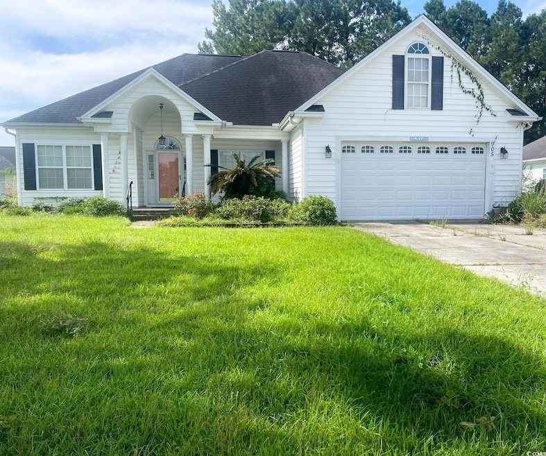 View of front of house with driveway, a front lawn, a garage, and a shingled roof