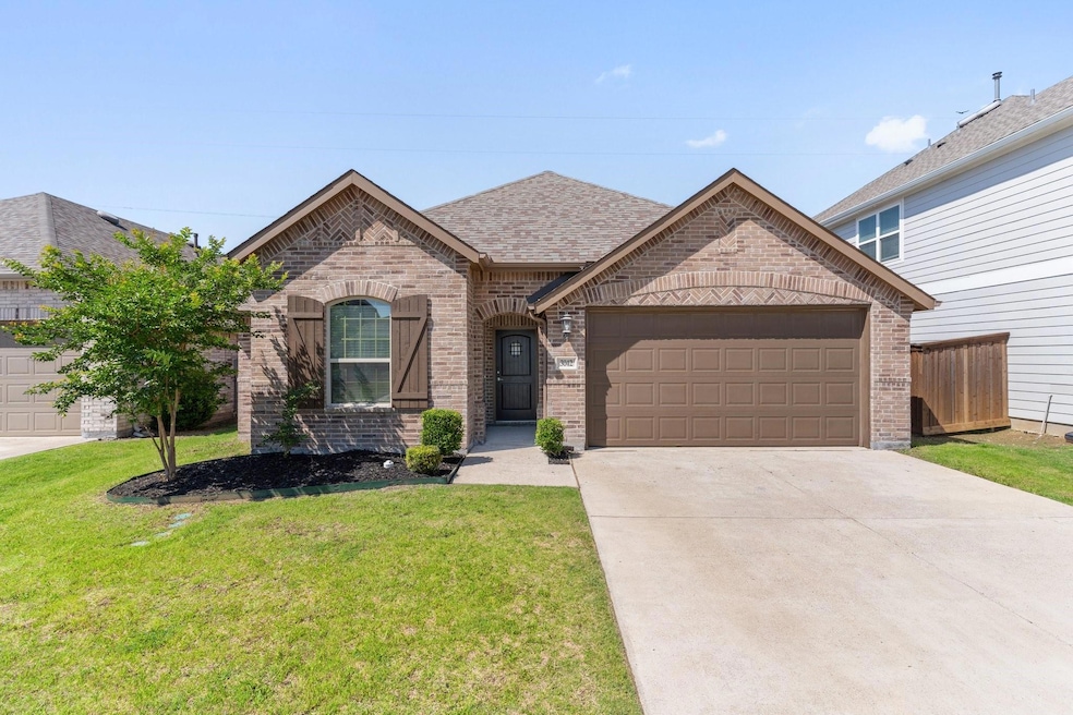 View of front of house with a front yard and a garage