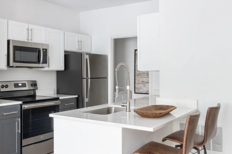 Kitchen featuring light countertops, a kitchen bre