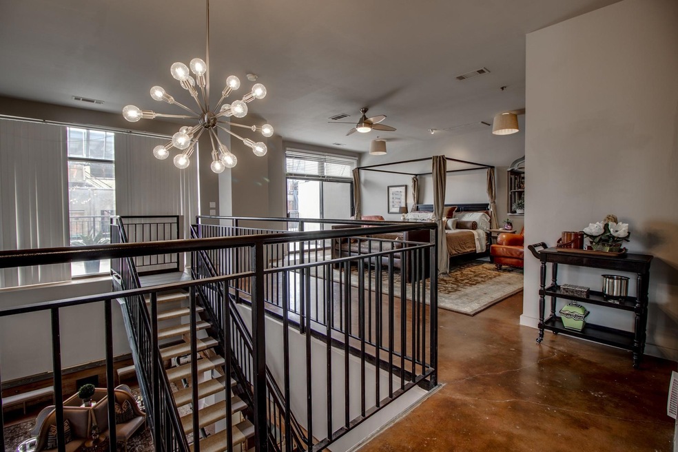 Staircase featuring a chandelier from the Office A