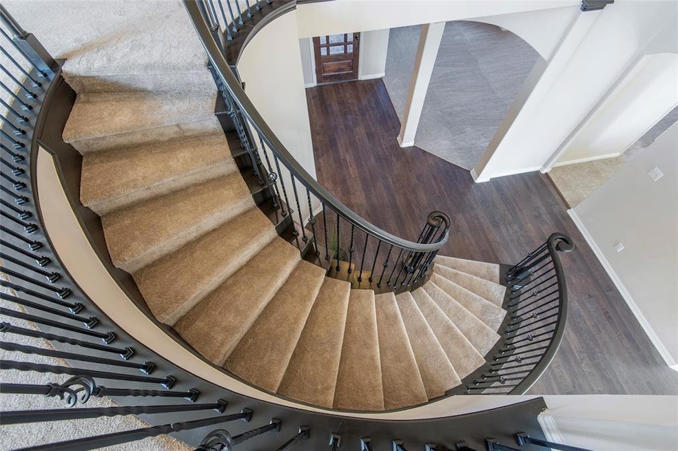 Stairs with baseboards and wood finished floors