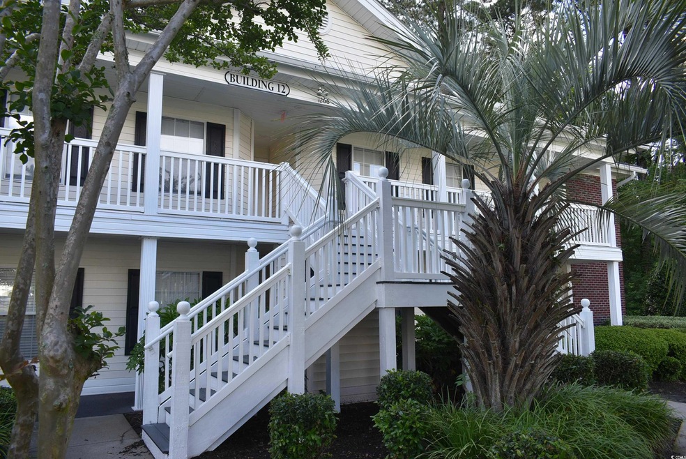 View of side of property featuring covered porch a