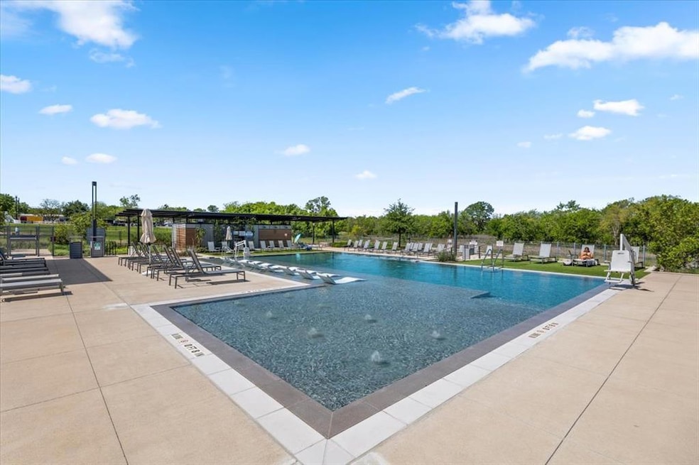 Community pool featuring a patio