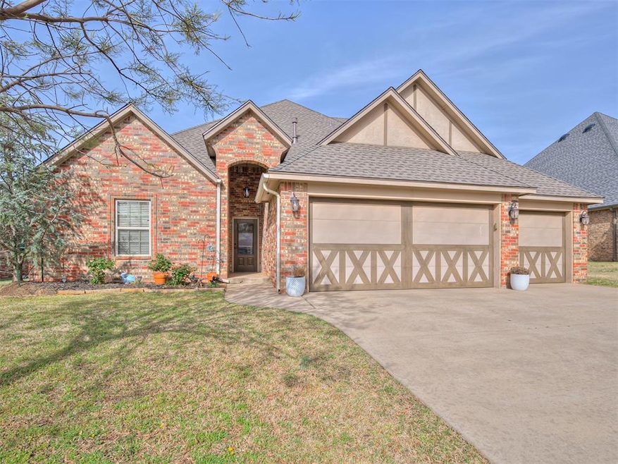 Single story home featuring a garage, a front yard