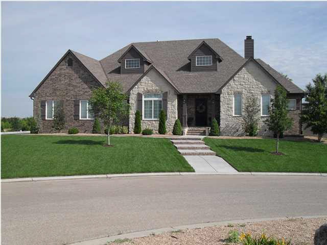 Beautiful Stone & Brick Custom home features a sid
