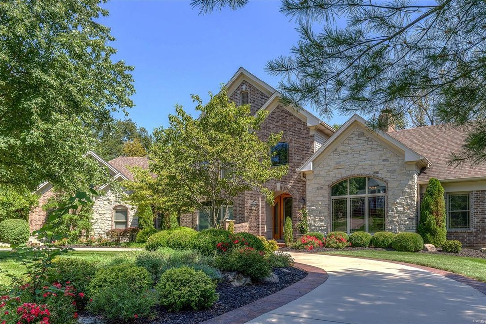 A beautifully manicured setting welcomes you to 13401 Mason Grove Lane.