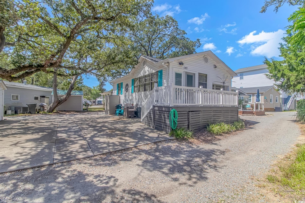 View of front of house featuring a wooden deck