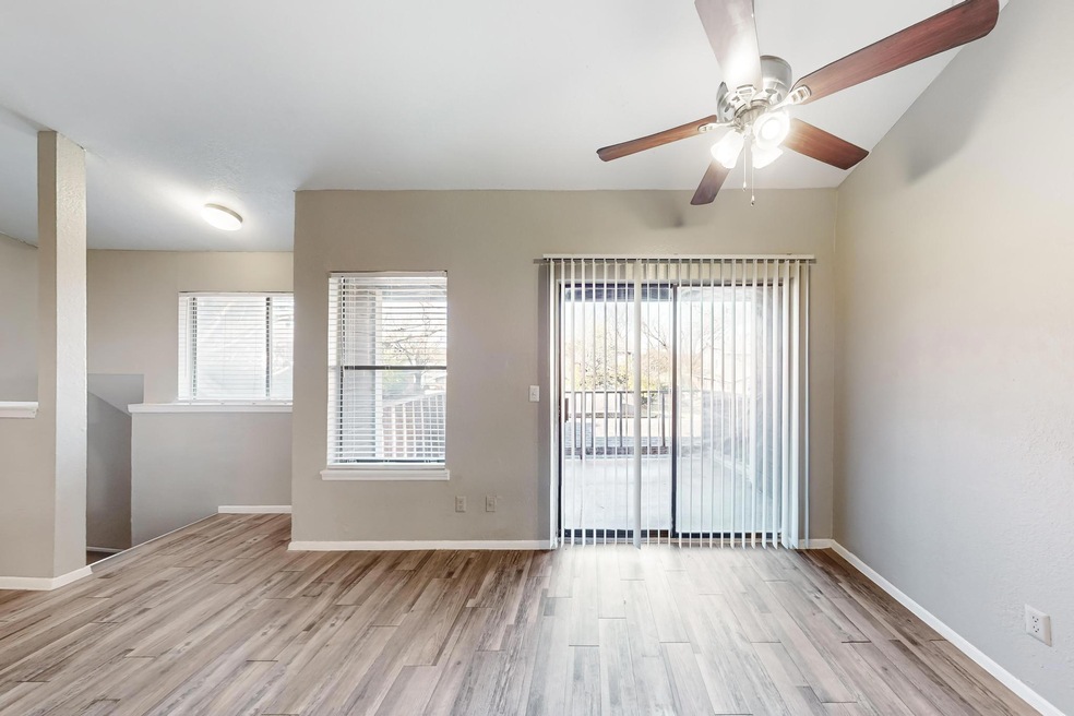 Empty room with ceiling fan and light hardwood / w
