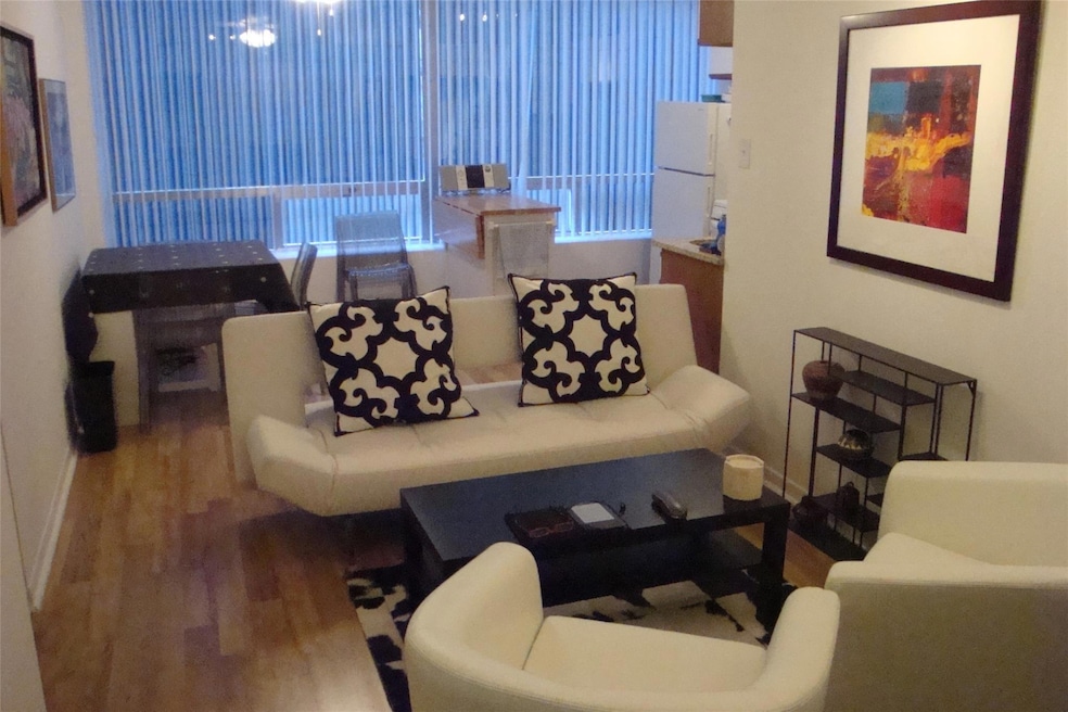 Living area with wood finished floors and baseboa