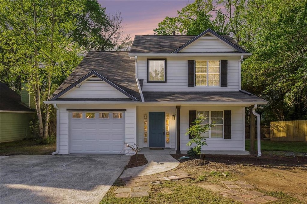 Traditional-style home with covered porch, roof wi