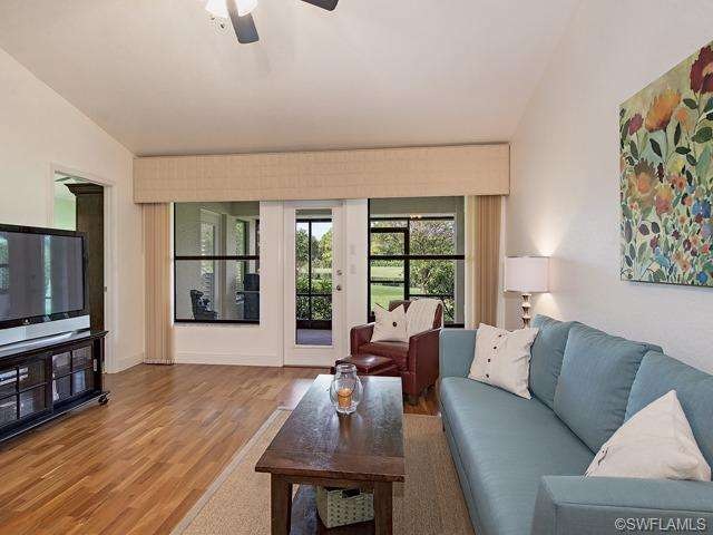 Living Room view onto lanai and lake/golf course