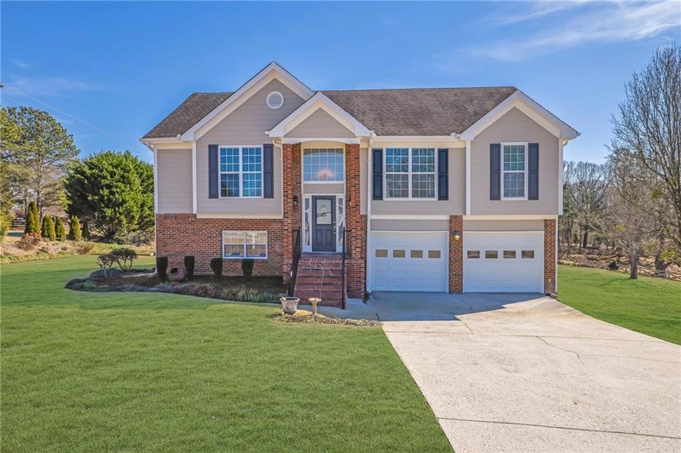 Split foyer home featuring brick siding, roof with