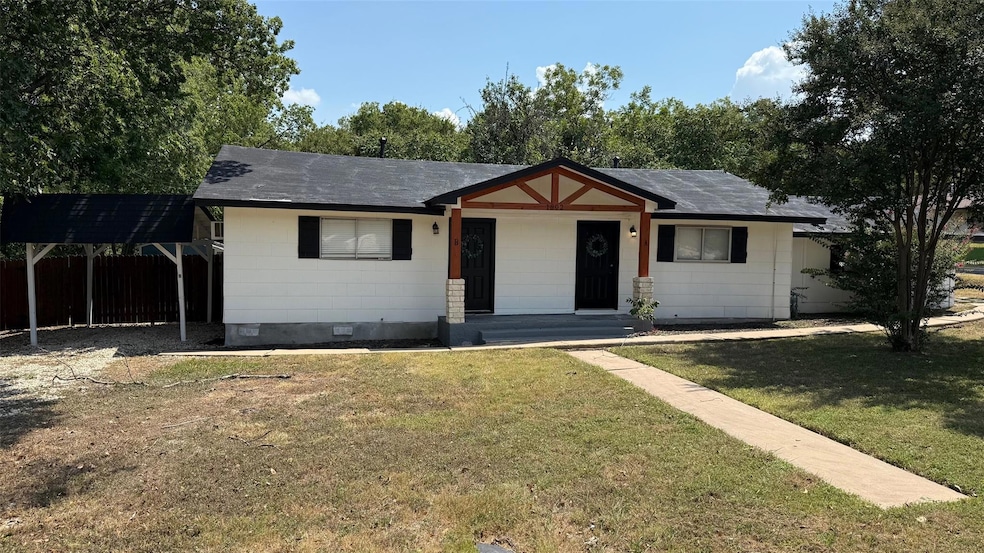 Single story home with crawl space, roof mounted solar panels, roof with shingles, and a carport