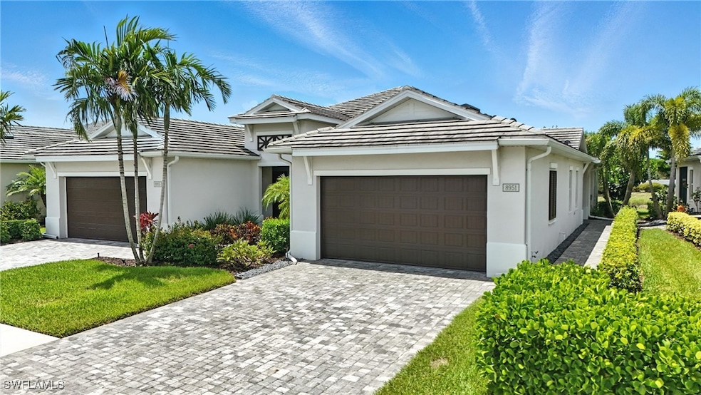 Ranch-style home with stucco siding, a garage, dri