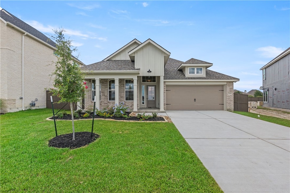 View of front facade with driveway, brick siding,